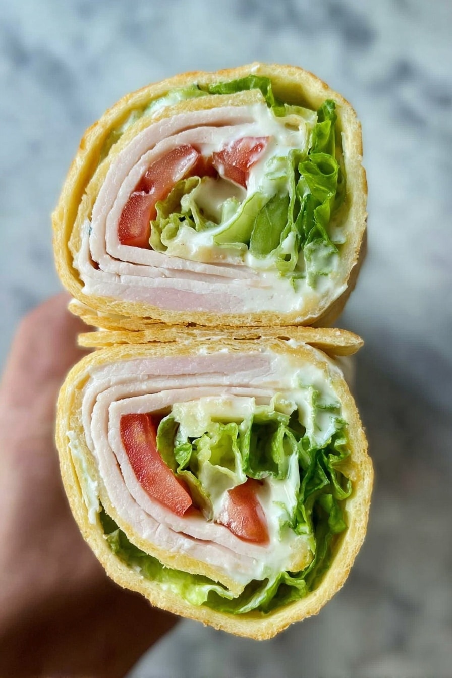 The image shows a close-up of two pieces of a rolled sandwich held in a woman's hand. The sandwich has three main visible layers: the outer layer is a light yellow, soft wrap, the middle layer is thin slices of pale white turkey, and inside there are bright green lettuce leaves mixed with small red tomato slices and a creamy white sauce. The roll looks fresh and neatly cut, showing the colors and textures clearly. The background is a white marbled surface. photo taken with an iphone --ar 2:3 --v 7 - Cottage Cheese Flatbread, easy flatbread recipe, homemade flatbread, quick flatbread for pizza and wraps, soft and buttery flatbread