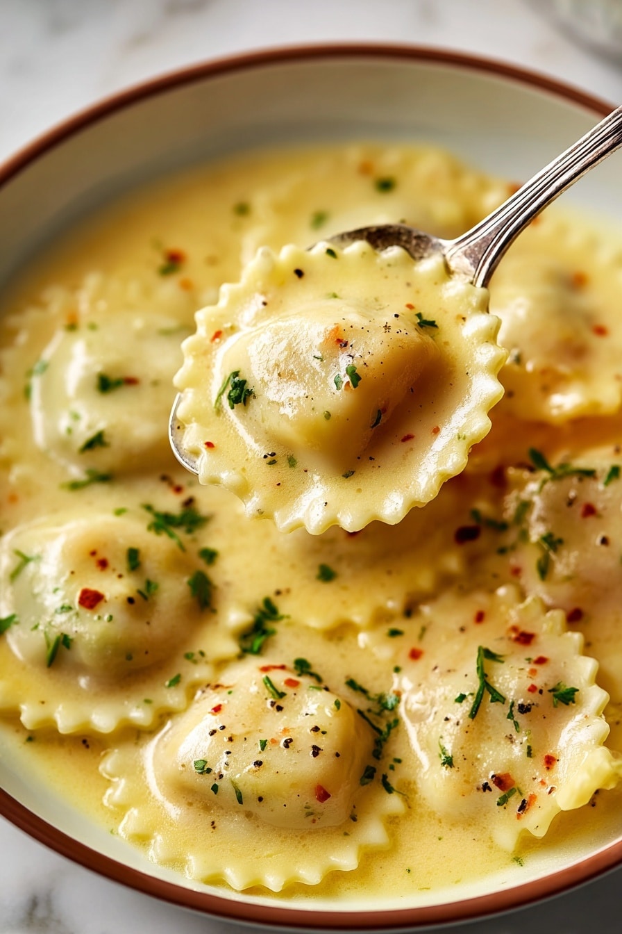 A close-up view of nine round ravioli pieces with scalloped edges, each topped with small chunks of bright orange seafood. The ravioli and seafood sit in a thick, creamy pale yellow sauce that fills the plate. Small green herb leaves, likely thyme, and tiny black pepper specks are sprinkled over the ravioli and sauce, adding texture and color. The dish is served in a white bowl with brown rim edges, placed on a white marbled surface. Photo taken with an iphone --ar 2:3 --v 7 - Lobster Ravioli with Lemon Butter Sauce, lobster ravioli recipe, lemon butter pasta, seafood ravioli dish, luxurious comfort food